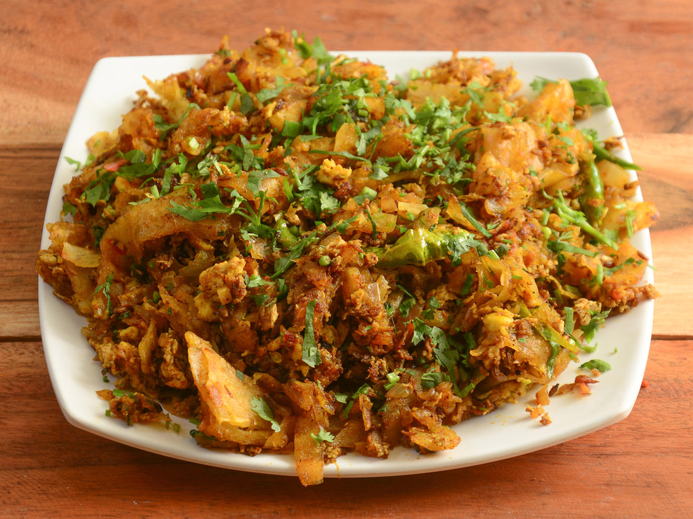 Kothu Parotta featuring finely chopped parotta mixed with seasonings and ingredients in a flavorful preparation