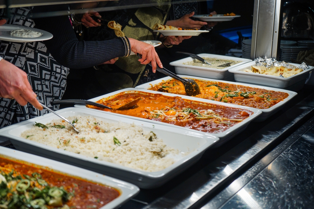 Indian Lunch Buffet featuring a selection of curries, rice dishes, breads, and accompaniments arranged for serving